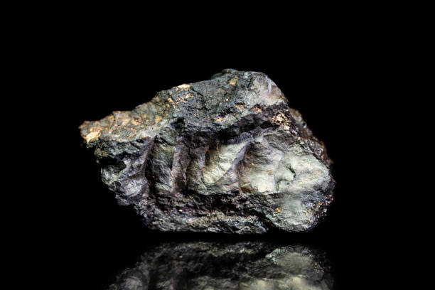 Stannite, tin and copper iron ore, raw rock on black background, mining and geology, mineralogy